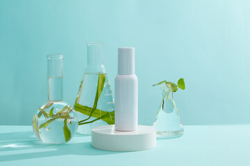 White cosmetic container standing on round-shaped podium. Some glassware of seaweed surrounded. Seaweed can help to remove dead skin cells and hydrate the skin © Tuan  Nguyen 