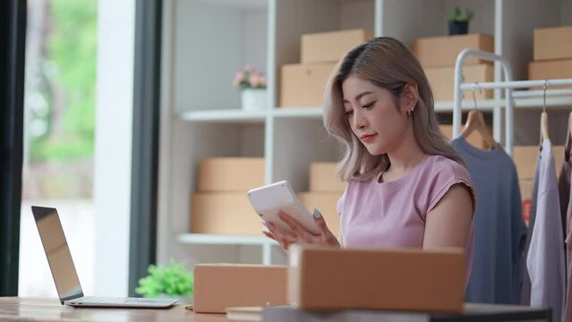 Entrepreneur beautiful business asian young woman work online with laptop at home.Freelance woman working online sale order fashion marketing at home.Small Business Startup concept.