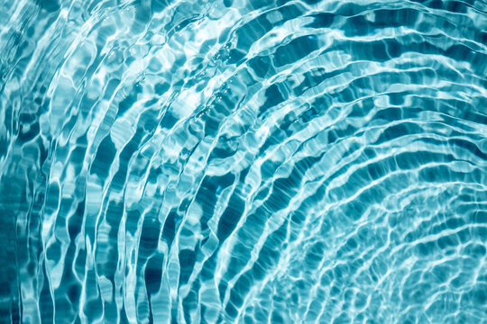 surface of swimming pool shining blue water ripple background