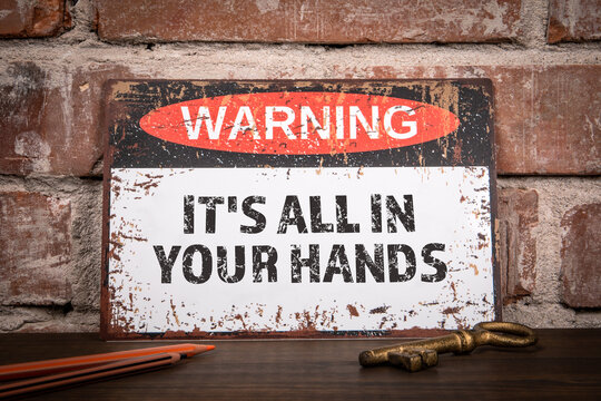 It's All In Your Hands. Warning sign with motivational text