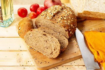 Home made Sliced bread with sesame seeds on wooden cutting board.