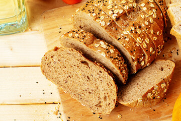 Sliced bread with sesame seeds on the wooden table.
