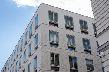 Fototapeta premium modern facade decorated with textured plaster with selected non-textural frames around windows