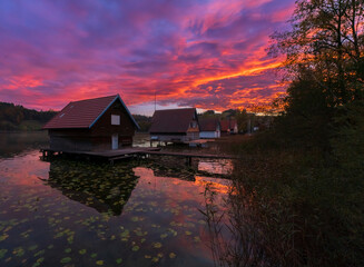 Fototapeta premium Sunrise frames at the lake houses on the alpsee lake in the bavaria region of germany