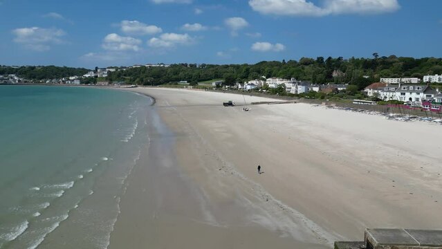 Lone person walking on beach St. Aubin's Bay Jersey channel Islands drone,aerial