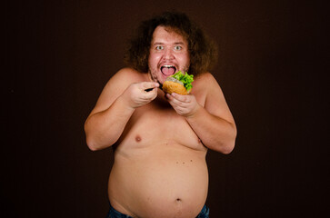 Diet and poor nutrition. Funny fat man posing in the studio.