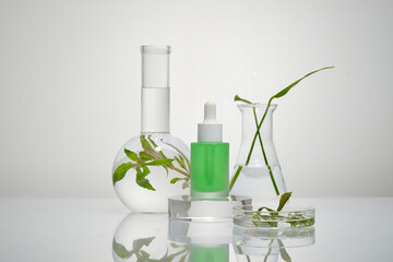 Dropper bottle full of green fluid is standing on a transparent podium. Branding mockup design. Seaweed can improve skin tone and pigmentation