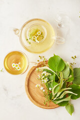 Tea brewing process, tea ceremony, cup and teapot of freshly brewed herbal natural tea flat lay.