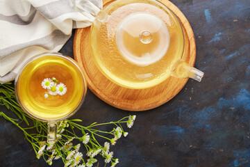 Glassware with healthy organic herbal linden, chamomile tea . Natural warm beverage, cozy table setting.