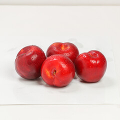 Ripe plums, fresh red plums on dark tone. background of beautiful home plums