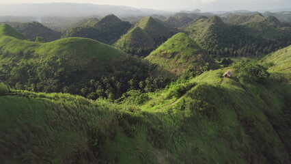Timelapse green grass hills aerial: building, path at mounts ranges. Beautiful Filipino nobody...