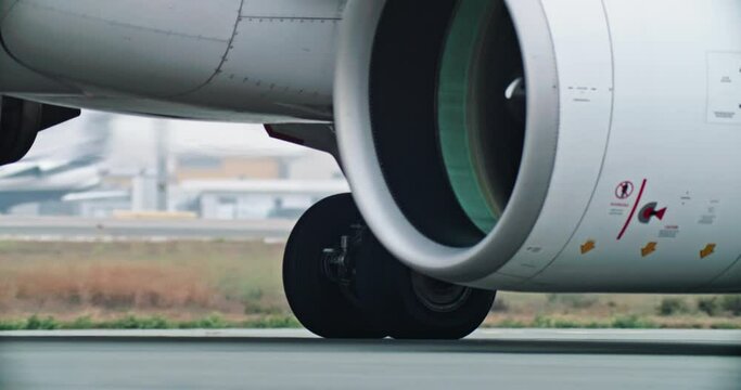 Dynamic Close-Up Footage: Captivating View of Airplane Wheels Gliding Along the Vibrant Airport Runway. High quality 4k footage