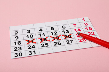 Women's calendar with a marker on a pink background