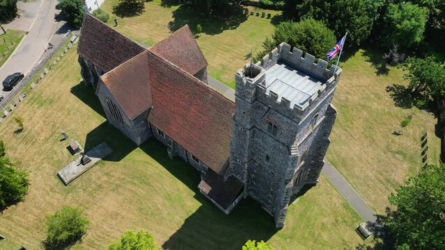 An arc-shot of St Mary's church in Chartham, with a union flag clearly flying from the church tower.