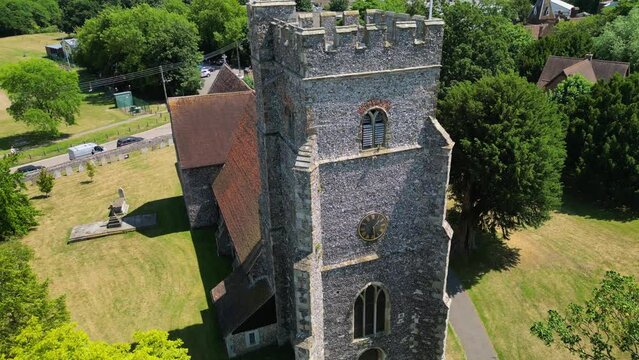 An upward-tilt shot of St Mary's church in Chartham, tilting up to reveal the union flag flying from the tower.