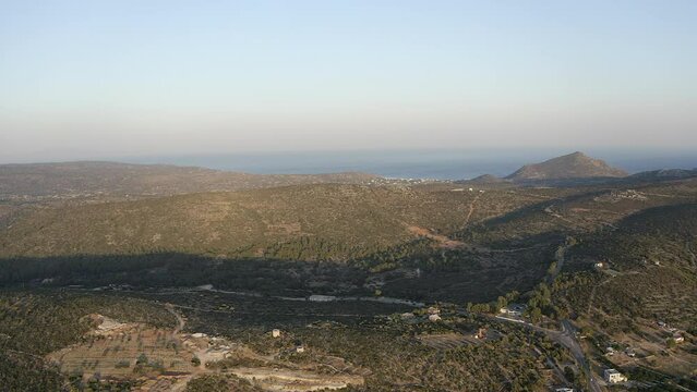 Aerial rises over sparce arid hill landscape on Greek island of Chios