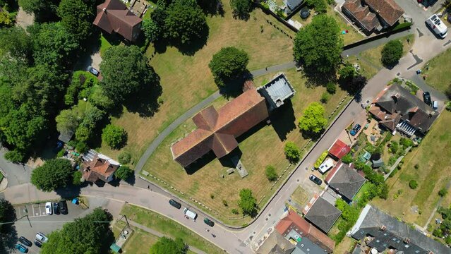 A top-down roll-shot of St Mary's church in Chartham, with parts of the village in view.
