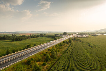 Aerial panoramic photo from above with A1 highway road between Sebes and Deva. Drone photo with the roads of Romania. Aerial view during sunset after a summer storm.