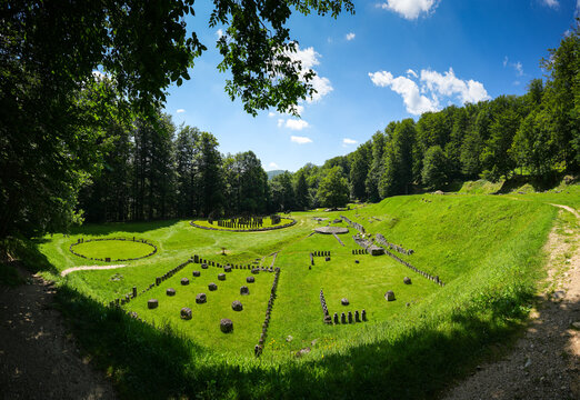 Sarmizegetusa Regia historical landmark in Romania. Wide angle photo during a sunny day in the middle of green forest Orastiei Mountains. Landmarks of Romania.