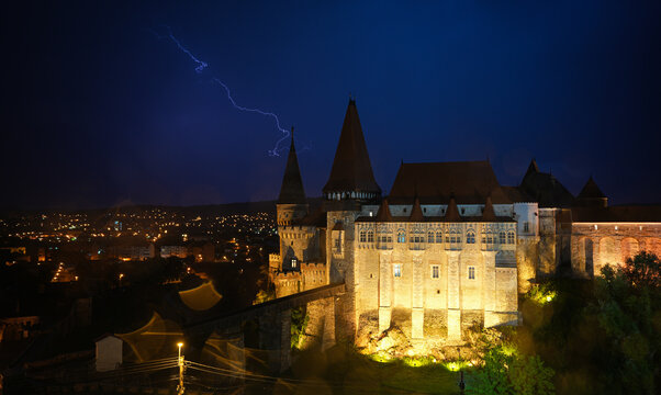 Summer thunderstrike storm at the medieval architecture Corvin (Hunyad) Castle in Hunedoara. Wide photo thunderstorm sky over Corvinilor Castle (in Romanian language).