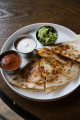 Traditional chicken quesadilla with sauces