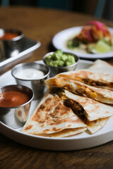 Traditional chicken quesadilla with sauces
