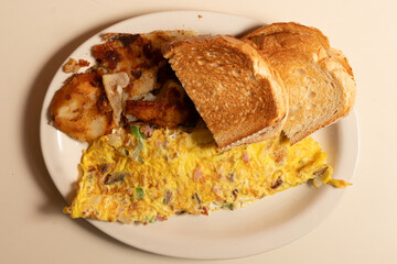 Veggie omelet with toast and home fries