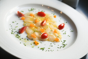 Scallop crudo with tomatoes and herbs