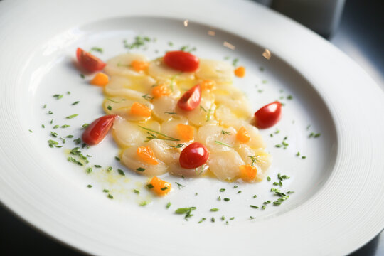 Scallop crudo with tomatoes and herbs