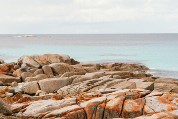 Heaps of Rocks and clear water at Bay of Fires near Suicide Beach via the Gardens Road, in Tasmania, North East Tasmania, Australia