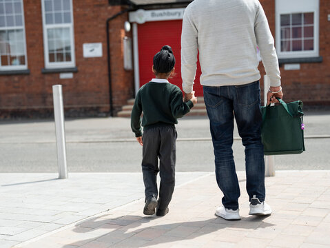 Father walking son (6-7) to school