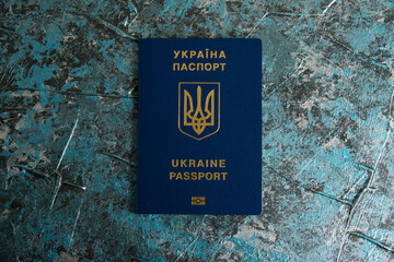 Foreign passport of a Ukrainian on a dark background with copy space. The concept of Ukrainians...