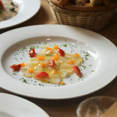 Scallop crudo with tomatoes and herbs