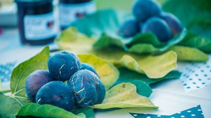 Figs with jars of fig jam on the table.