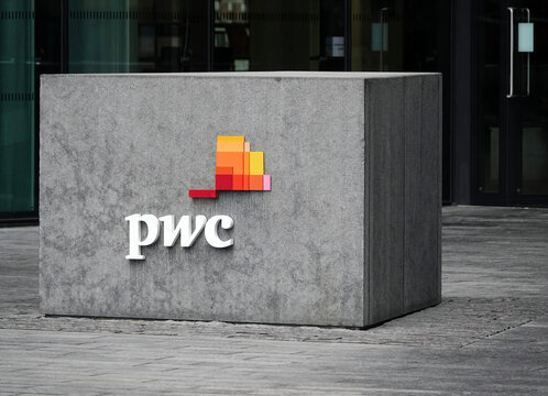 London, UK - January 29, 2023: Modern pwc sign and logo on a concrete block at the entrance to the offices of PricewaterhouseCoopers plc at 7 More London, Riverside, London, England. 