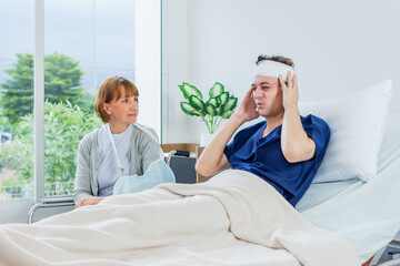 Fototapeta premium The patient has a headache while lying in the hospital room with Gauze Bandage Wrapped Around Head.