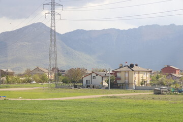 High-voltage power lines against the background of mountains in the province of Konya, May 1, 2023, Turkey.