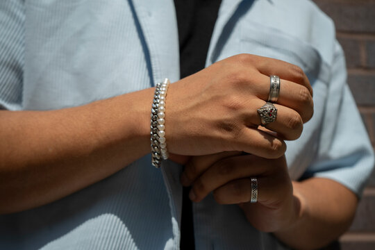 Man wearing bracelets and rings