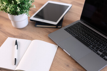 Fototapeta premium Wooden table with office supplies, top view