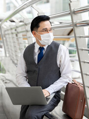 Portrait asian business man wearing protective face mask for protection during the quarantine...