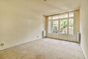 an empty room with white walls and no one person in the room looking out to the garden through the window