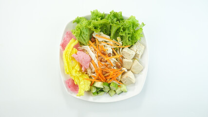 Raw vegetable salad or Asinan Betawi is a traditional food from Indonesia made of cabbage bean sprouts tofu cucumber carrot peanut sauce crackers