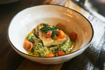 Baked cod with tomatoes and potato mash