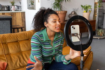 Female influencer recording a vlog in a cool loft studio apartment