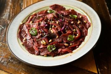 Venison carpaccio with pine nuts