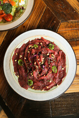Venison carpaccio with pine nuts