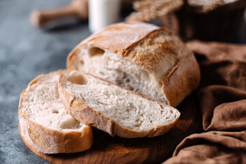 Close up sliced loaf of freshly baked homemade on the table. Whole grain white bread. Healthy...