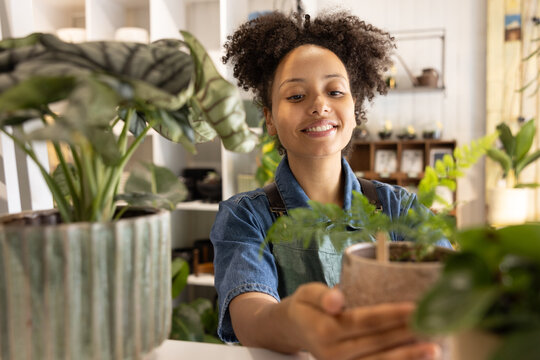 Plant shop owner setting up store before opening