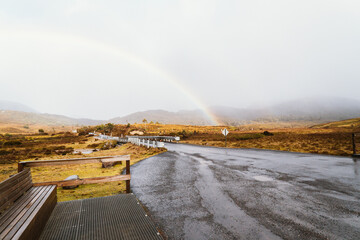 Rainbow across road at Ronny Creek in Cradle Mountain, Tasmania, Australia