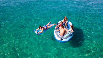 Single mother with happy children enjoy the rubber boat while floating on the beautiful sea. enjoying on inflatable boat. happy mother, brother and three sisters. wonderful calm sea. Tourist concept